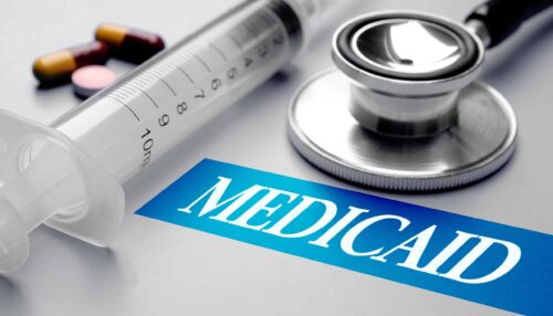 Medicaid,,Health,Concept.,Stethoscope,,Syringe,And,Pills,On,Grey,Background.